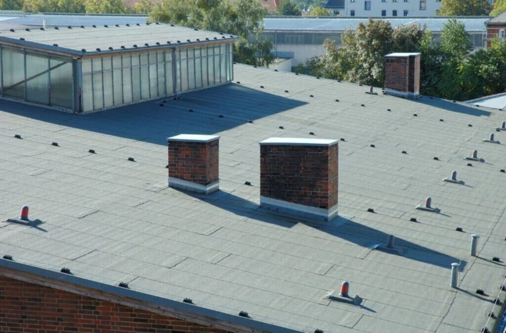 A Strive Roofing & Construction employee providing expert commercial roofing services in Porter, TX, showcasing professional tools and skills to ensure top-quality results.