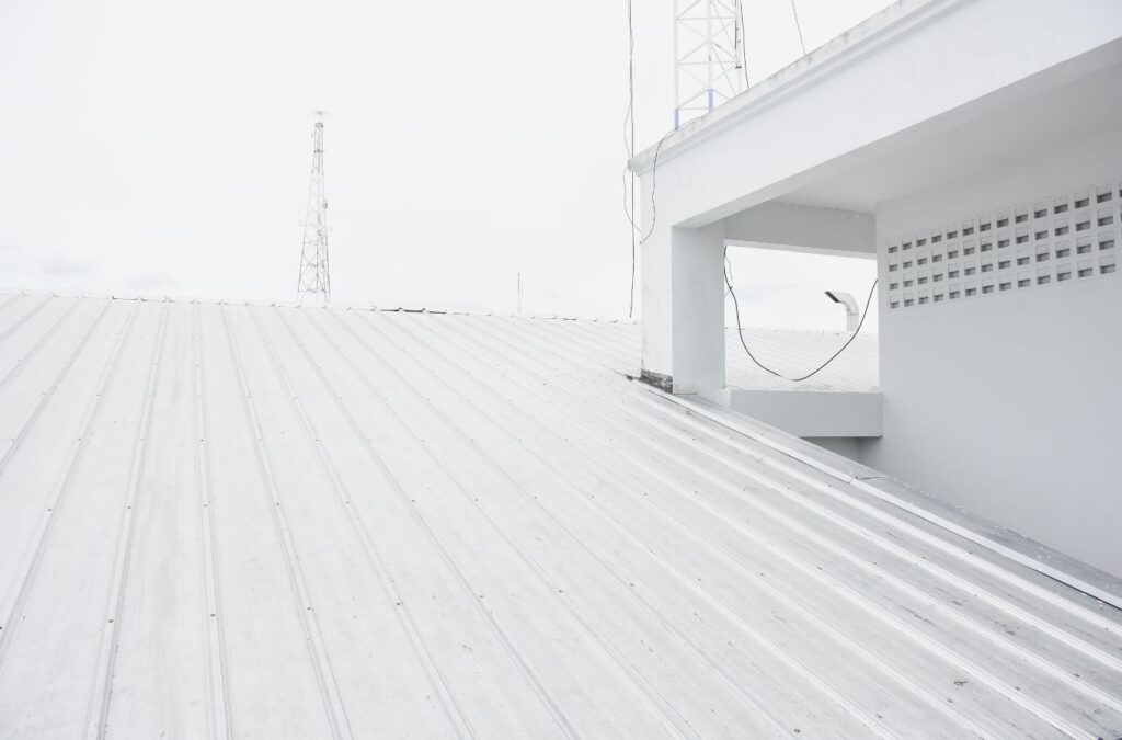 A Strive Roofing & Construction team member applying Roof Coating in Houston, TX, showcasing the value of professional service for roof longevity and efficiency.