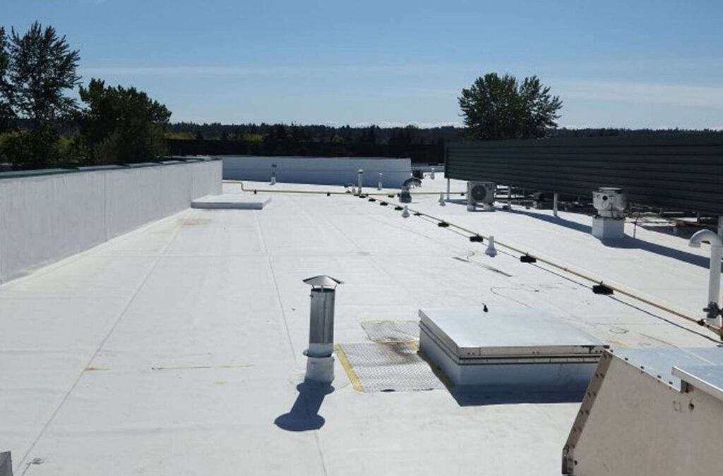 A Strive Roofing & Construction team member applying TPO Roofing in Kingwood, TX, showing the value of skilled workmanship and efficient roofing performance.