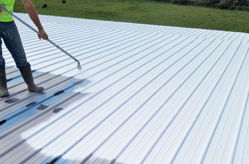 A Strive Roofing & Construction employee applying Roof Coating in Spring, TX, using precision tools to protect surfaces and enhance building energy performance.