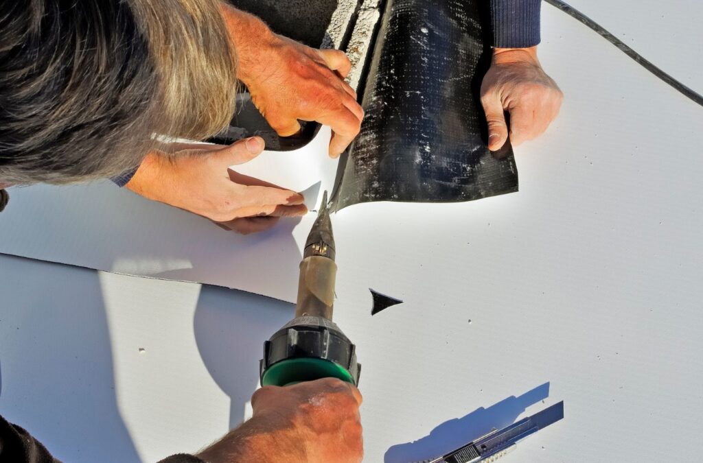 A Strive Roofing & Construction technician applying TPO roofing in Houston, TX, showcasing our commitment to superior commercial roofing solutions. TPO Roofing near me.