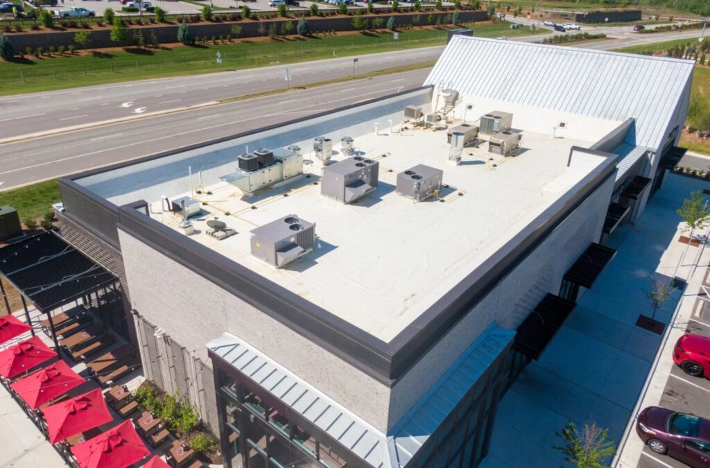 A Strive Roofing & Construction expert performing TPO Roofing in The Woodlands, TX, showcasing top-tier commercial service and commitment to quality. TPO Roofing near me.