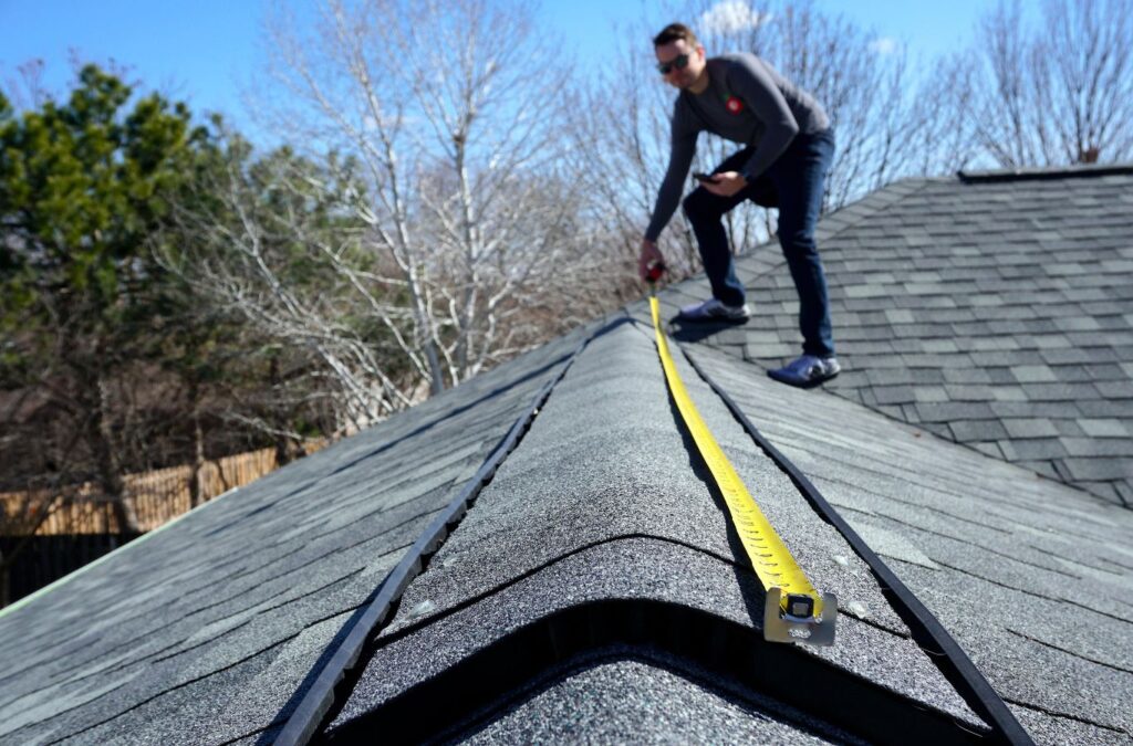 A professional from Strive Roofing & Construction performing a roof inspection in The Woodlands, TX to highlight our expertise and local service quality. Roof Inspection near me.