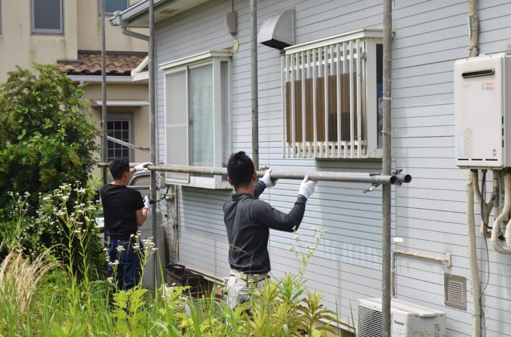 Strive Roofing & Construction team member painting home exterior in Spring, TX showing quality and local expertise