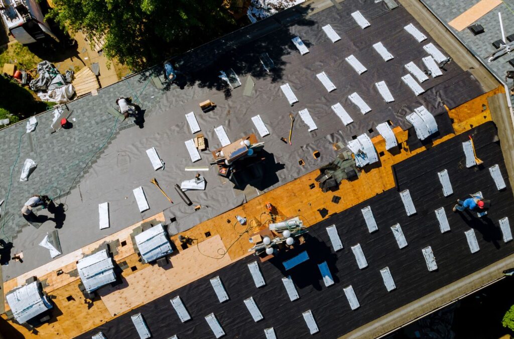 Strive Roofing & Construction team member fixing roof damage in Spring, TX ensuring safety and local expertise
