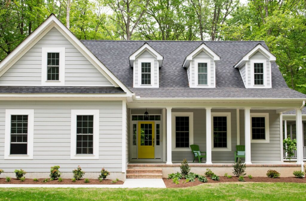 Strive Roofing & Construction painter applying exterior coating in Spring, TX using pro tools for durable finish